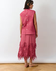 Back view of Dust Rose Kazari Skirt highlighting tailored construction and hem detail.
