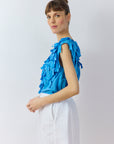 Side profile of the Hane Vest in Hana Blue showing the relaxed fit and raw-edged lawn ribbons by Yaccomaricard.