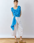 Model wearing the Sukafu Belt in Hana Blue, showing the elegant scarf-like drape and pintuck texture.