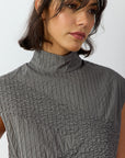 Close-up detail of lightweight cotton lawn fabric and intricate pintuck stitching on Shibo Shell Top.