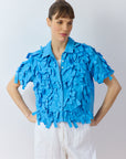 Front view of Yaccomaricard Hane Shirt in Hana Blue with ribbon texture and casual silhouette.