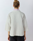 Back view of Yaccomaricard Faneru Jacket in Cool Grey highlighting the continuous horizontal pintucks in garment-dyed cotton.
