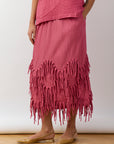 Side view of Dust Rose Kazari Skirt showing flowing silhouette and mid‑length design.