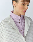 Close-up of the softly funnelled neckline and soft cotton jersey on the Yaccomaricard Faneru Jacket in cool grey.