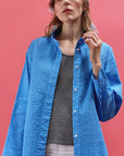 Model wearing Nikku Shirt in Hana Blue from Yaccomaricard showcasing casual cotton layering.