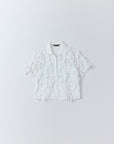 Flat lay of Yaccomaricard of Hane Shirt  adorned all over with a plumage of raw-edged ribbons.