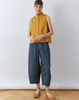 Shot of a model wearing Brown Sugar Kantan Jersey Waistcoat by Yaccomaricard, showing its boxy fit.