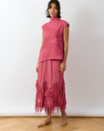 Kazari Skirt in Dust Rose slight angle view showing textured panels and fluid shape.
