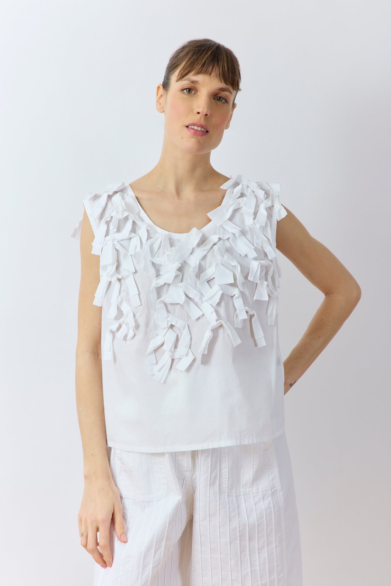 Front view of Yaccomaricard Hane Vest in white featuring textured cotton lawn ribbon embellishment.