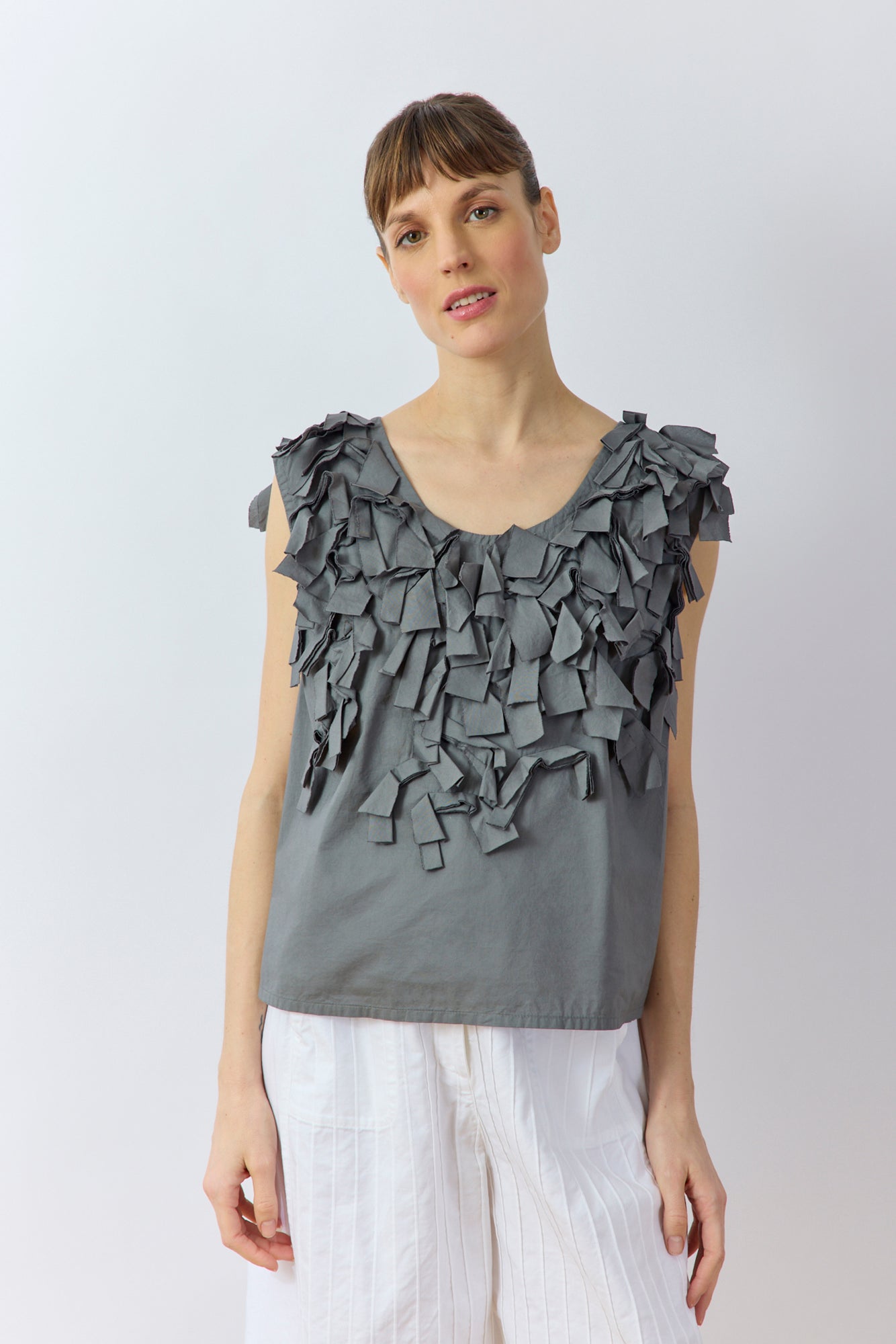 Front view of Yaccomaricard Hane Vest in metal grey with sculptural cotton lawn ribbon texture.