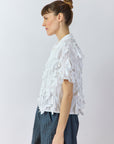 Side view of white Yaccomaricard Hane Shirt showing sculptural raw-edge ribbon texture.