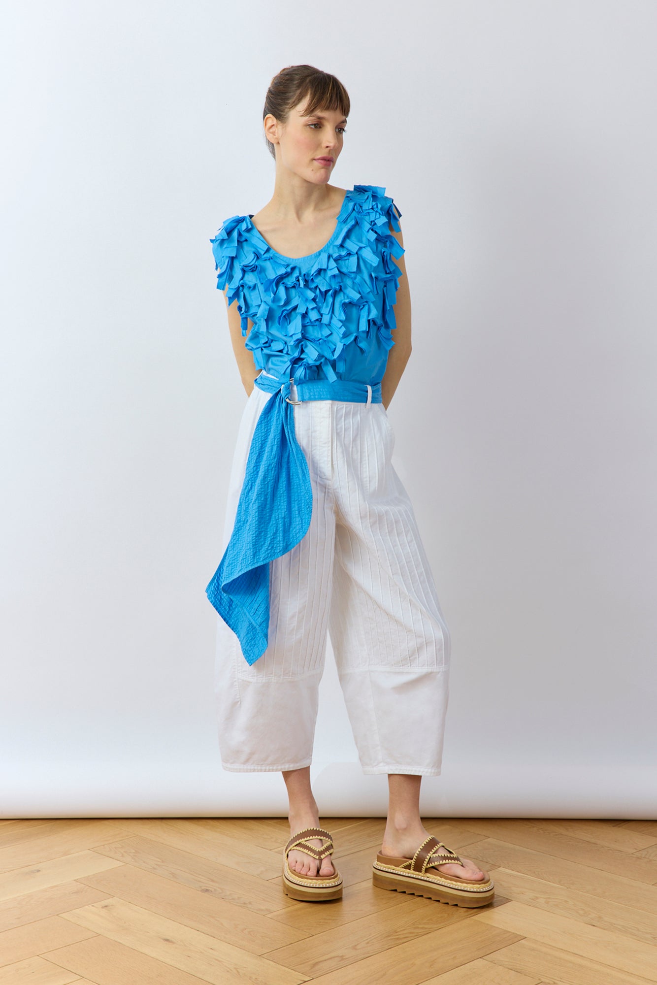 Model wearing the Sukafu Belt in Hana Blue, showing the elegant scarf-like drape and pintuck texture.