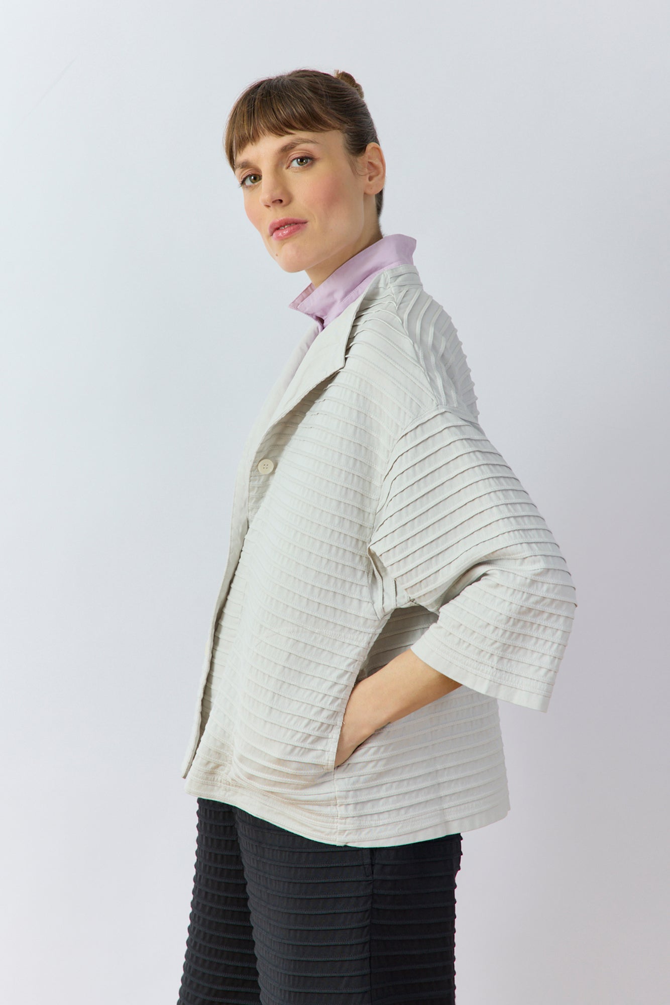 Side profile of the Faneru Jersey Jacket in Cool Grey showing the relaxed A-line swing silhouette.