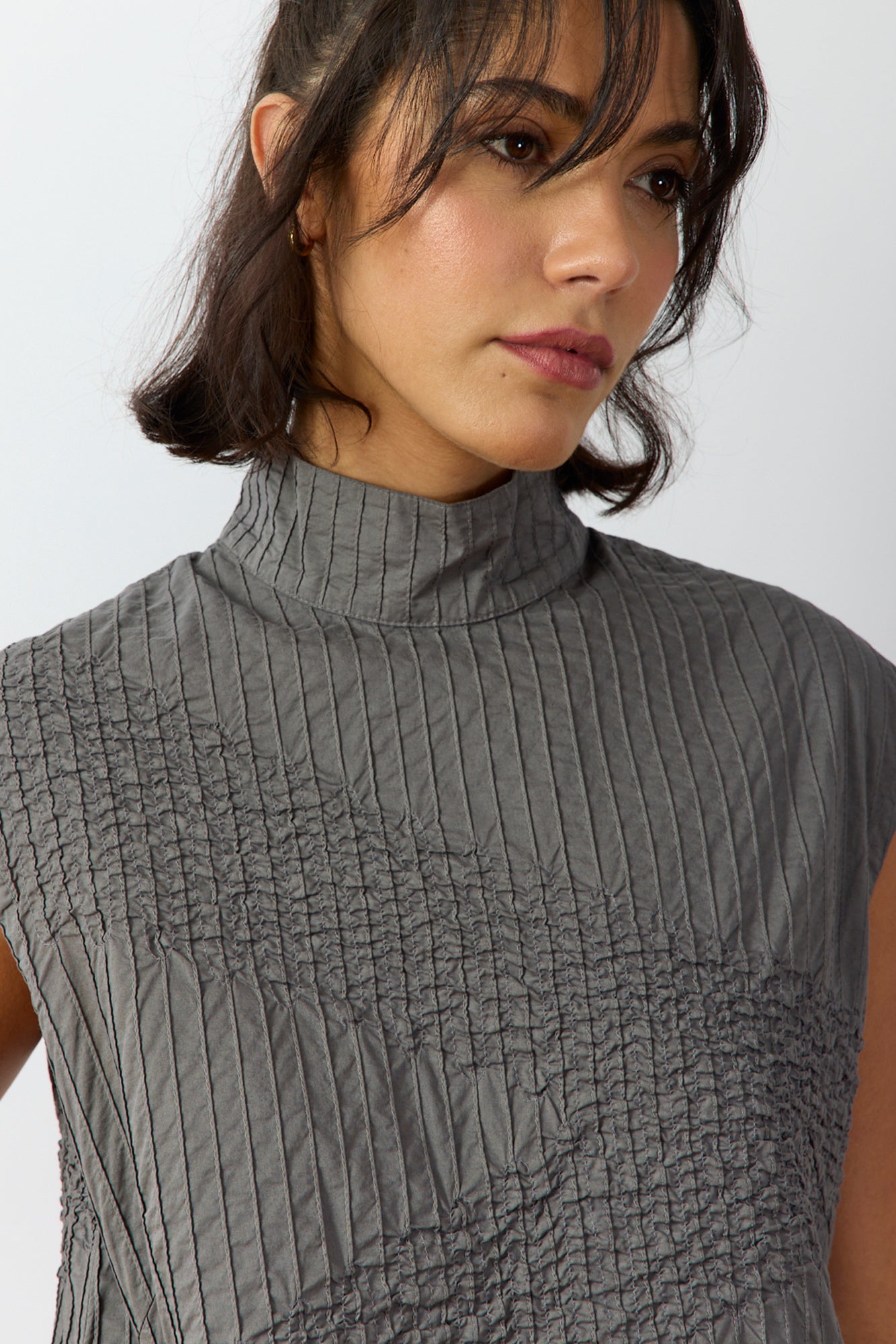 Close-up detail of lightweight cotton lawn fabric and intricate pintuck stitching on Shibo Shell Top.