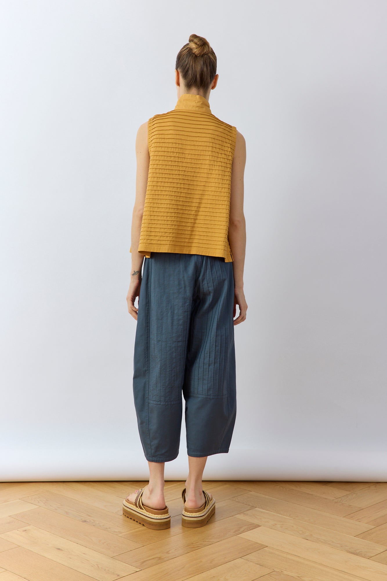Back view of Yaccomaricard Obaru Trouser in Stone Blue featuring signature pintuck panels.