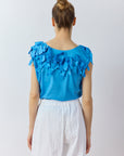 Back view of Yaccomaricard Hane Vest in hana blue with textured lawn ribbon detailing.