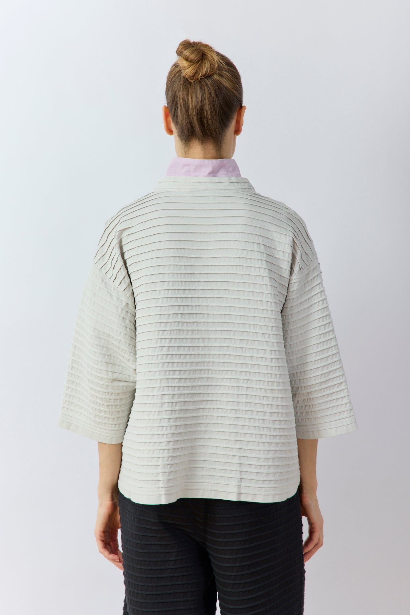 Back view of Yaccomaricard Faneru Jacket in Cool Grey highlighting the continuous horizontal pintucks in garment-dyed cotton.