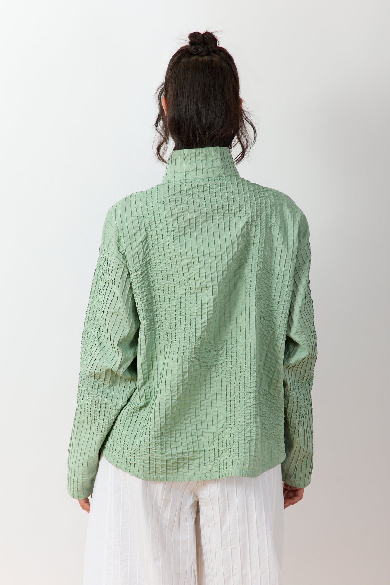 Back view of Powder Green Shibo Jacket showing relaxed fit and quilting-inspired smocking detail.