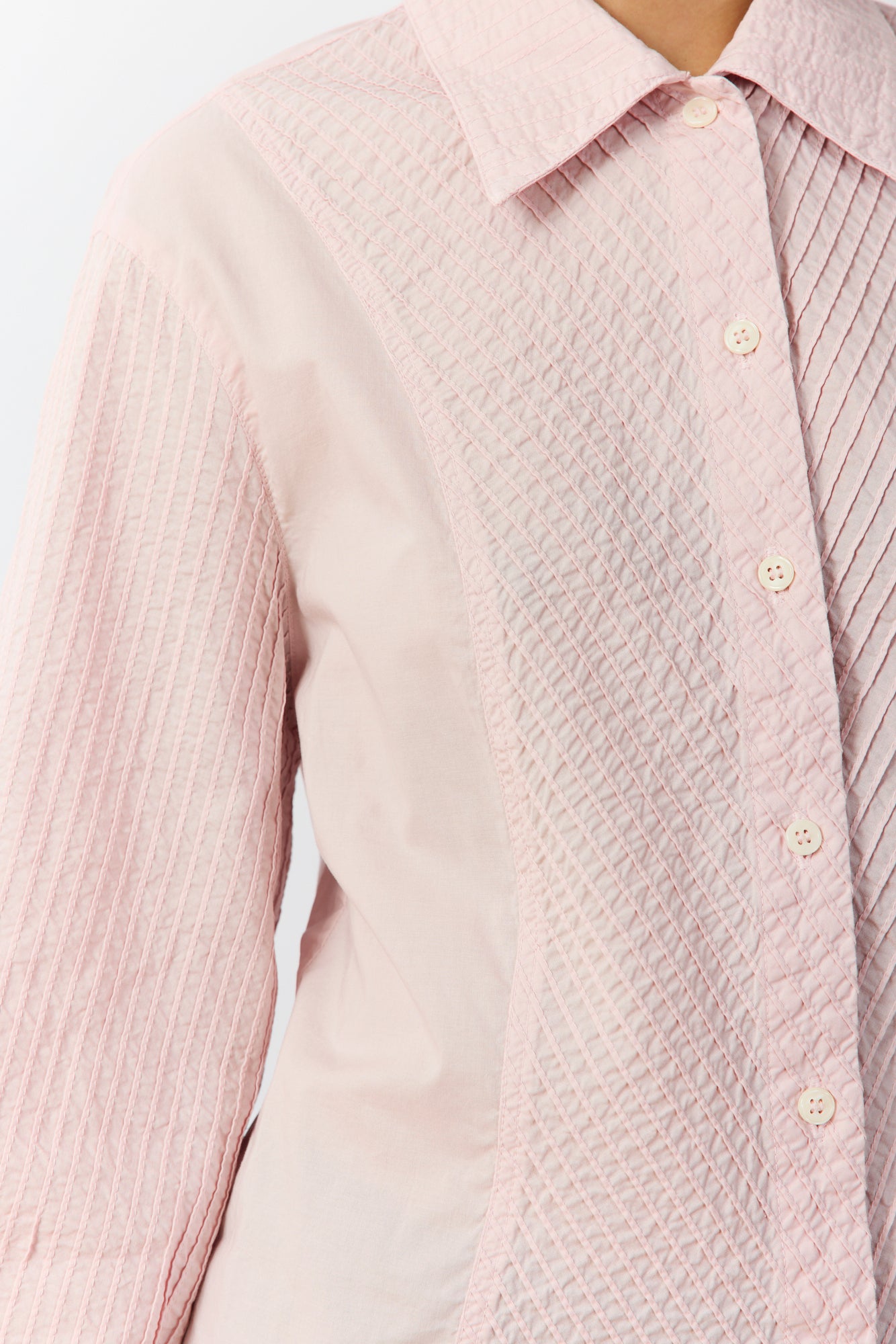 Detail shot of the garment-dyed cotton lawn and tailored sleeves with refined cuffs in Sakura.