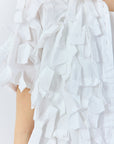 Close-up of raw-edged ribbon texture on white Yaccomaricard Hane Shirt cotton lawn.