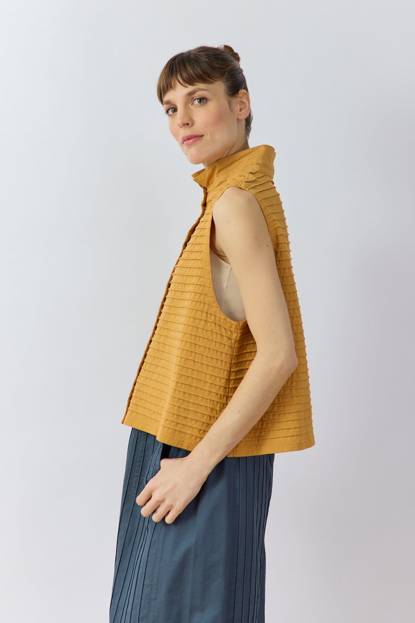 Side profile of the Kantan Jersey Waistcoat in Brown Sugar by Yaccomaricard showing the boxy fit, generous armholes, and side splits.