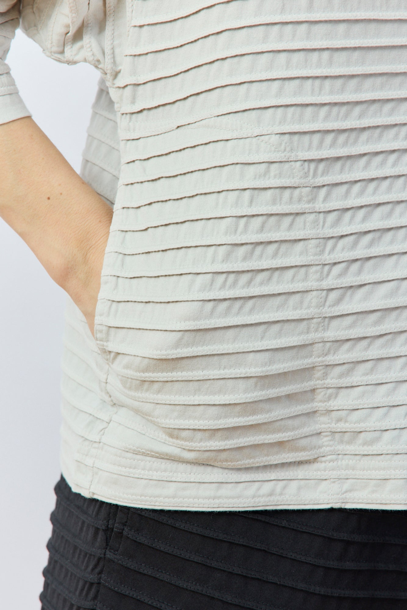 Close-up of pocket detail on Yaccomaricard Faneru Jersey Jacket in Cool Grey.