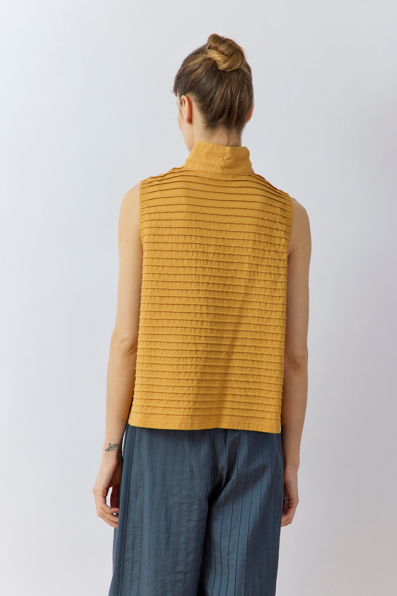 Back view of Yaccomaricard Kantan Waistcoat in Brown Sugar highlighting the continuous all-over pintuck texture.