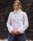 Model wearing white Shibo Jacket with textured pintuck cotton design and relaxed silhouette.