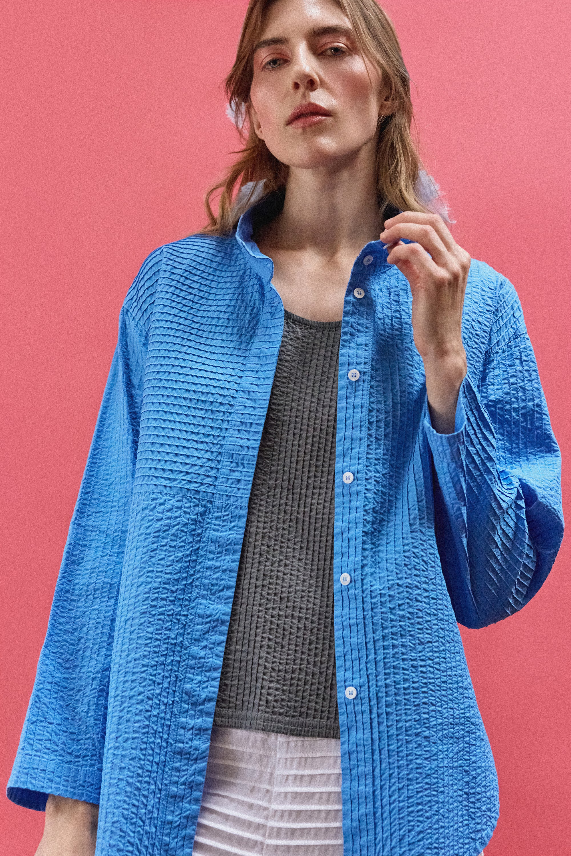 Model wearing Nikku Shirt in Hana Blue from Yaccomaricard  showcasing casual cotton layering.